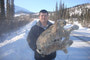 Sgt Barker holding up a Lynx that was caught in a snare.