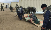 US forces help an injured civilian out of the line of fire in the village.