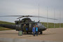 Corporal Kint Dube of 408 Tactical Helicopter Squadron standing next to a Griffon static display with .50 Calibre door mounted machine gun.