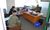 Corporal Calvin Delisle, Chief Warrant Officer Antony Batty, and Andrew Ference debate football/soccer teams in deep discussion!