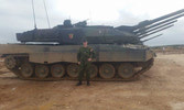 Sgt Dave Brister poses next to a squadron of Portuguese Leopard 2s taking part in Exercise TRIDENT JUNCTURE 2015 in Santa Margarida, Portugal.