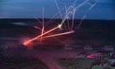 Coyote Reconnaissance Vehicles and Leopard 2 A4s night firing on the range.