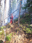 Tpr Thibault hosing down a flare up at Juliett Creek. Photo by Cpl Daniel Wynen 