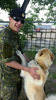 Tpr Deringer hugging a Golden Retriever and Husky mix from the local animal shelter in Prince Albert. The dog tried to escape the dog yard but was caught. Downtime during Operation LENTUS 15-02.