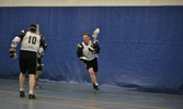 From left to right: Capt James “Crusher” Anderson setting a pick for Captian Mike “Breezy” Labrecque during a Lacrosse game against the senior NCO’s.