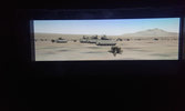 A troop of Bradley fighting vehicles lined up ready to go in the simulator.