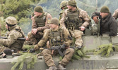 UAF soldiers hitch a ride on a BMP