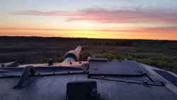 The crew of C/S 21B admire the sunset after a long night of shooting.