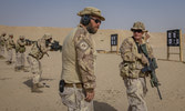 Cpl Clauson conducts a shoulder check during ASF training in Kuwait. Cpl Steele stanced second on the left of the firing line.