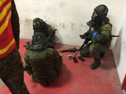 B Sqn soldiers, dressed in the simunition battle gear, loading their C8 magazines with simunition rounds in preparation for the room clearing exercise against a live enemy.
