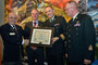 Lieutenant-Colonel (Retired) Bill Schultz presents a plaque to Lieutenant-Colonel Josh Major, Commanding Officer, on behalf of Loops for Troops